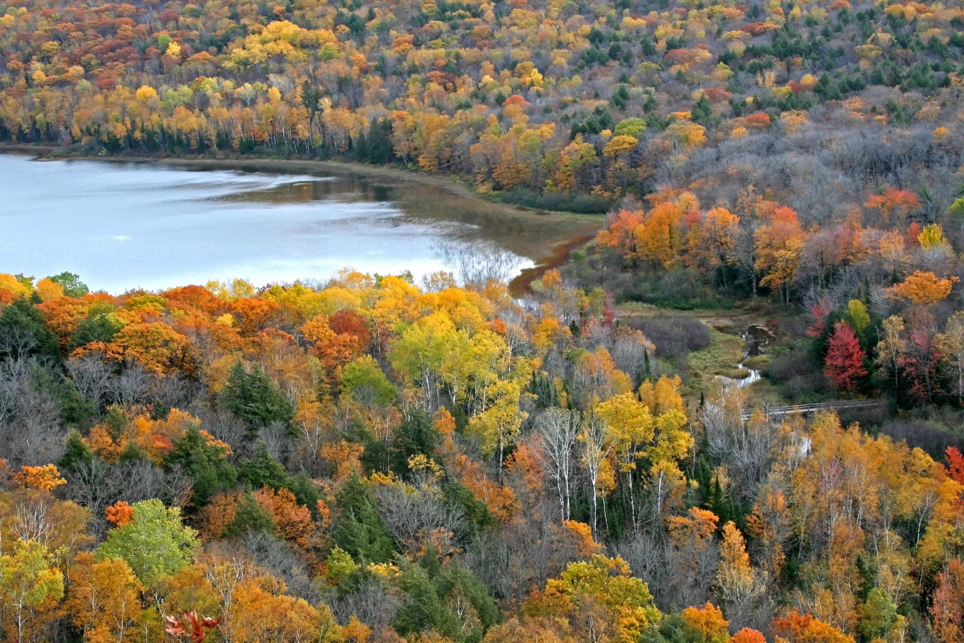 Porcupine Hills Provincial Park in the fall. A lake surrounded by colourful autumn trees.
