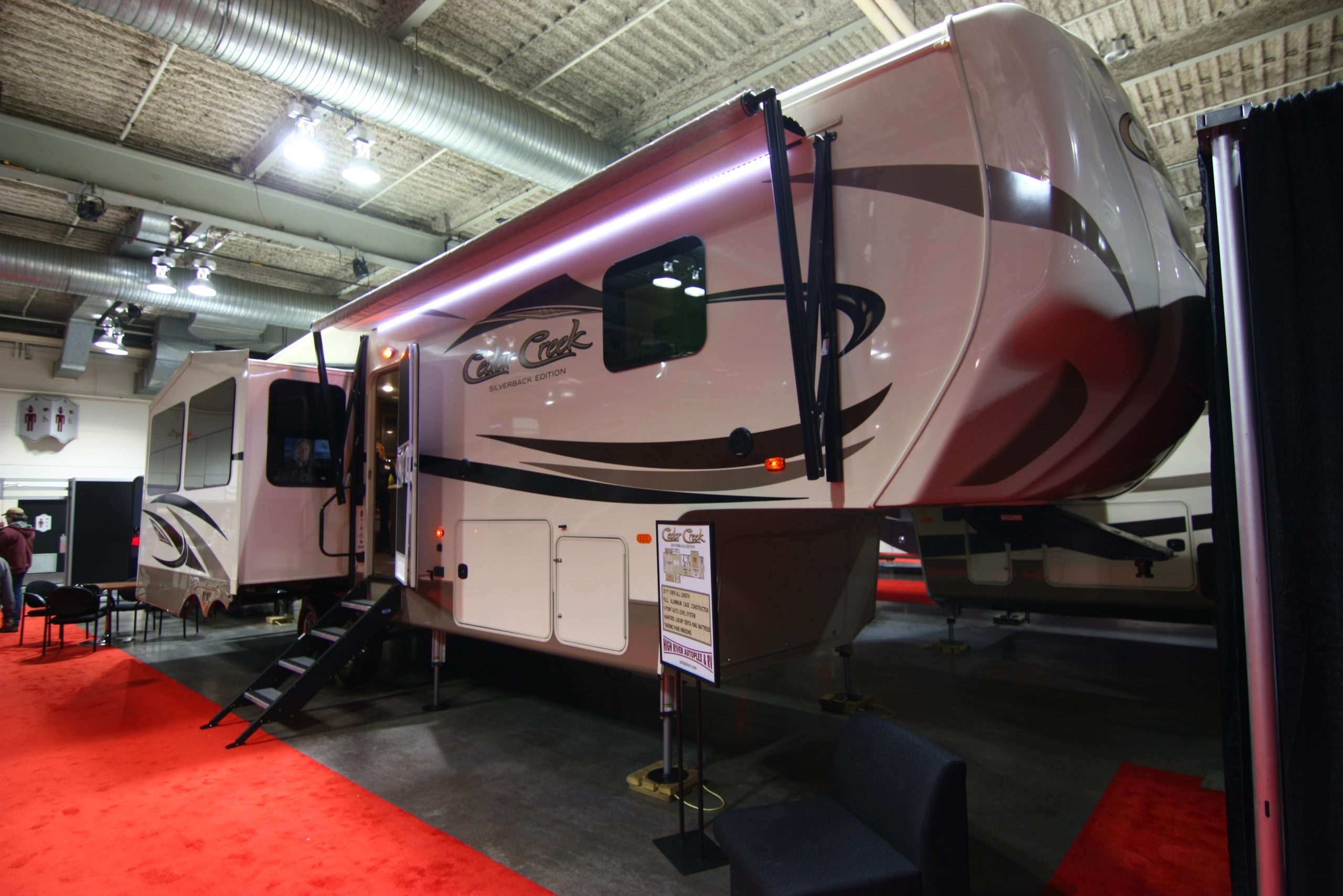 Luxury fifth wheel with an awning and slides at the 2017 Calgary RV Show.
