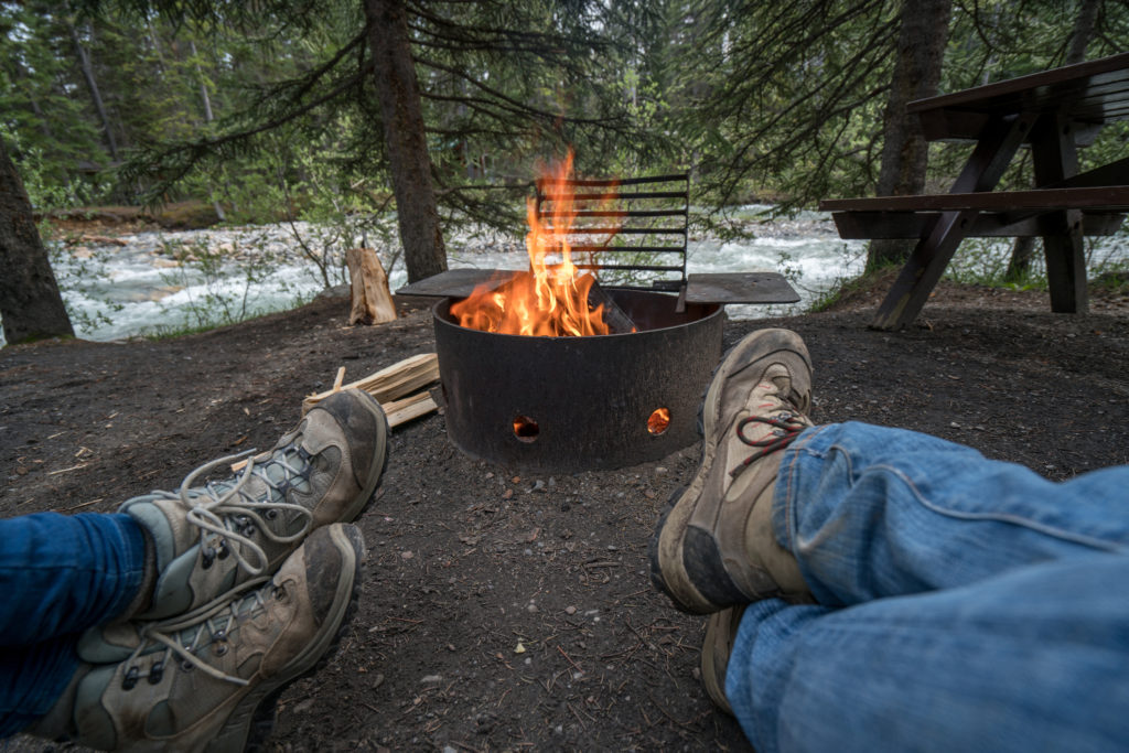 Relaxing by a campfire next to a creek in Kananaskis country.